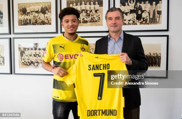 Jadon Sancho signs a new contract with Borussia Dortmund with Michael Zorc on August 31, 2017 in Dortmund, Germany.