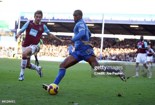 Sylvain Distin of Portsmouth competes against Valon Behrami of West Ham United during the Barclays Premier League match between Portsmouth and West...