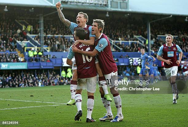 Craig Bellamy of West Ham United celebrates scoring their third goal with Mark Noble and Valon Behrami during the Barclays Premier League match...