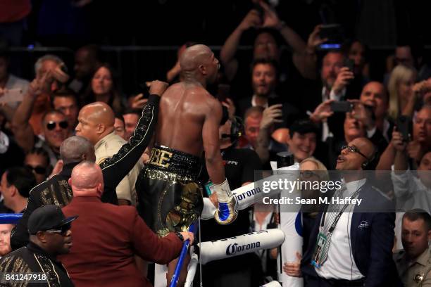 Floyd Mayweather Jr. Celebrates after his TKO of Conor McGregor in their super welterweight boxing match on August 26, 2017 at T-Mobile Arena in Las...