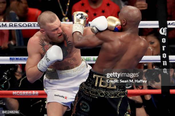Conor McGregor and Floyd Mayweather Jr. Exchange blows during their super welterweight boxing match on August 26, 2017 at T-Mobile Arena in Las...