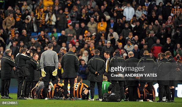 Hull City manager Phil Brown delibers his half time team talk on the pitch during the English Premier league football match against Manchester City...