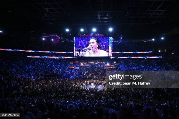 Singer Demi Lovato performs the national anthem before Floyd Mayweather Jr. And Conor McGregor compete in their super welterweight boxing match on...