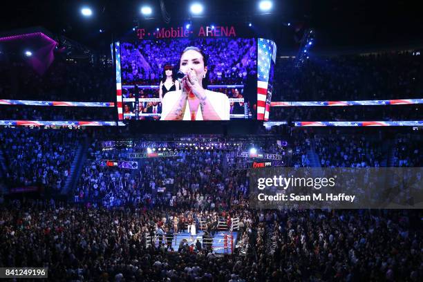 Singer Demi Lovato performs the national anthem before Floyd Mayweather Jr. And Conor McGregor compete in their super welterweight boxing match on...