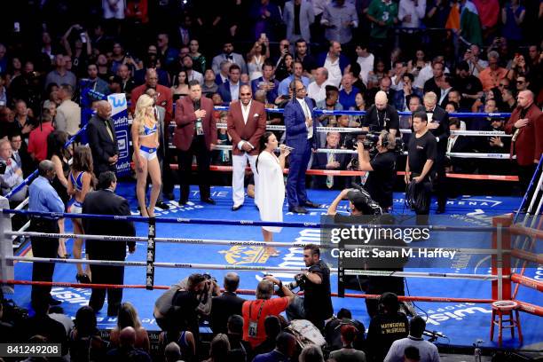Singer Demi Lovato performs the national anthem before Floyd Mayweather Jr. And Conor McGregor compete in their super welterweight boxing match on...