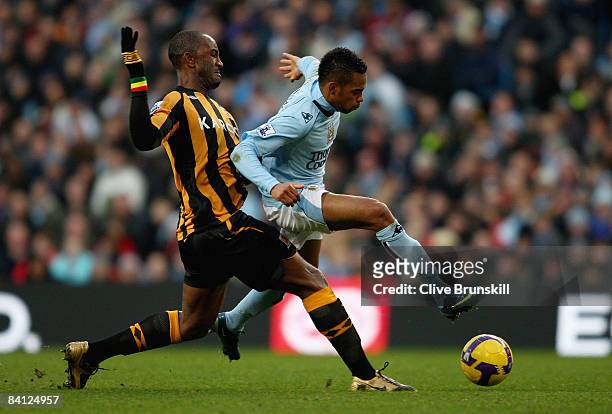 Robinho of Manchester City is tackled by Kamil Zayatte of Hull City during the Barclays Premier League match between Manchester City and Hull City at...