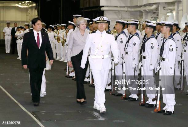 British Prime Minister Theresa May and Japanese Defense Minister Itsunori Onodera attend the welcome ceremony at Japan Maritime Self-Defense Force...