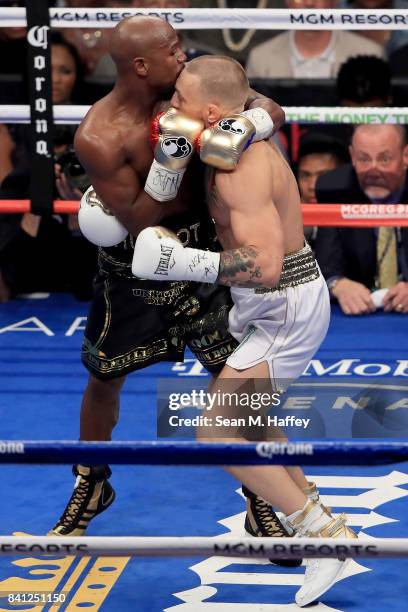 Floyd Mayweather Jr. Throws a punch at Conor McGregor during their super welterweight boxing match on August 26, 2017 at T-Mobile Arena in Las Vegas,...