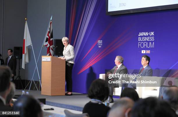 British Prime Minister Theresa May addresses while Japanese Prime Minister Shinzo Abe and International Trade Secretary Liam Fox listen during a...