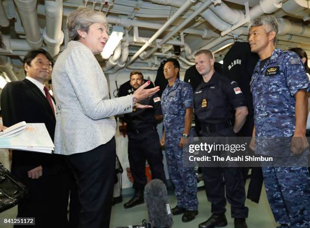 British Prime Minister Theresa May meets British and Japanese naval personnel on board at Japan Maritime Self-Defense Force helicopter carrier JS...