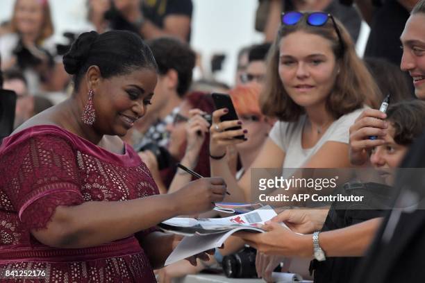 Actress Octavia Spencer signs autographs as she arrives at the premiere of the movie "The Shape of Water" presented in competition "Venezia 74" at...