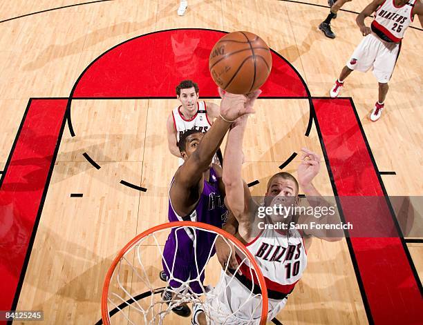 Joel Przybilla of the Portland Trail Blazers and Jason Thompson of the Sacramento Kings battle for a rebound during the game at the Rose Garden on...