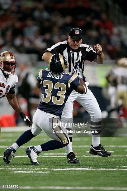 Kenneth Darby of the St. Louis makes contact with official Gary DeFelice during the NFL game against the San Francisco 49ers at the Edward Jones Dome...