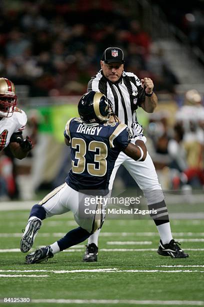 Kenneth Darby of the St. Louis makes contact with official Gary DeFelice during the NFL game against the San Francisco 49ers at the Edward Jones Dome...