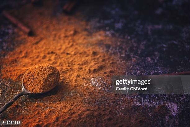 ground cinnamon on rustic background - spice powder stock pictures, royalty-free photos & images