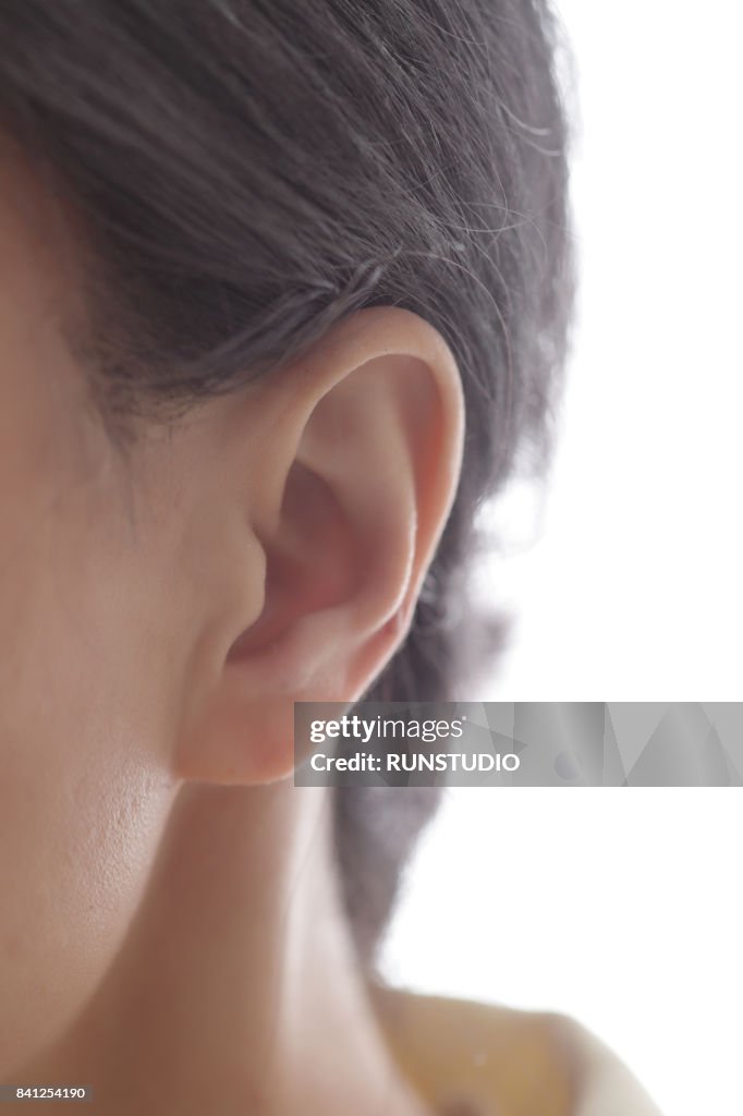 Middle aged woman's left ear and neck