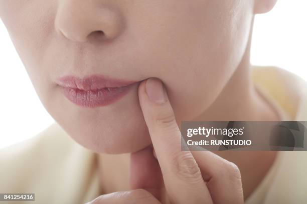 part of a middle aged woman's face - painful lips stock pictures, royalty-free photos & images