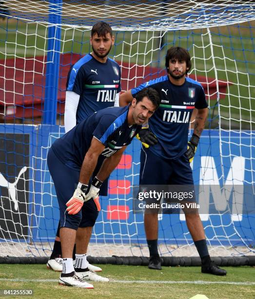 Gianluigi Donnarumma, Gianluigi Buffon and Mattia Perin of Italy look on during the training session at Italy club's training ground at Coverciano on...