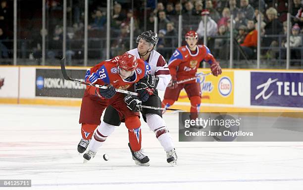 Martins Gipters of Latvia tries to slow down Nikita Filatov of Russia at the Civic Centre on December 26, 2008 in Ottawa, Ontario, Canada.