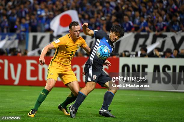 Shinji Okazaki of Japan and Brad Smith of Australia compete for the ball during the FIFA World Cup Qualifier match between Japan and Australia at...