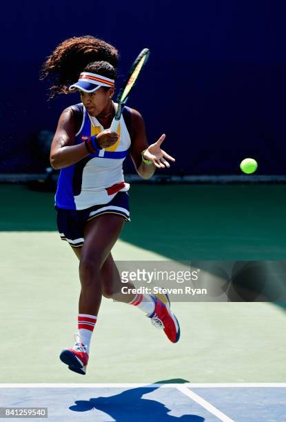 Naomi Osaka of Japan returns a shot against Denisa Allertova of Czech Republic during their second round Women's Singles match on Day Four of the...