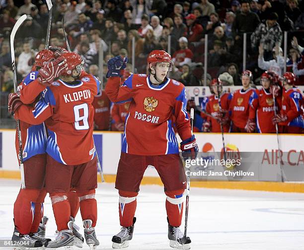 Maxim Goncharov of Russia celebrates his goal with his team mates Dmitri Klopov and Mikhail Pashnin against Latvia at the Civic Centre on December...