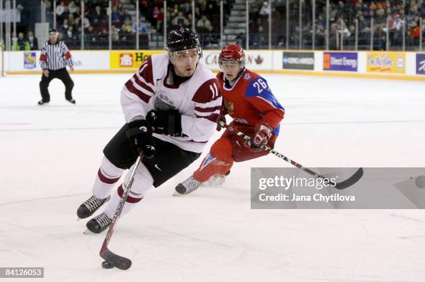 Roberts Bukarts of Latvia carries the puck as Evgeni Dadonov of Russia chases him at the Civic Centre on December 26, 2008 in Ottawa, Ontario, Canada.