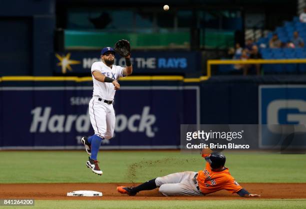 George Springer of the Houston Astros slides into second base ahead of second baseman Rougned Odor of the Texas Rangers before being called out on...