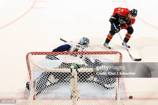 Goaltender Mike Smith of the Tampa Bay Lightning blocks a shot by Michael Frolik of the Florida Panthers in overtime at the Bank Atlantic Center on...