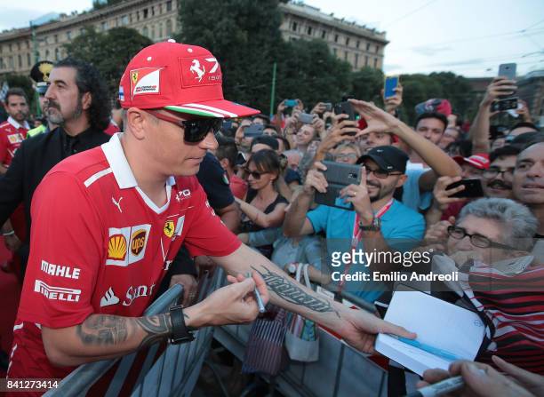 Kimi Raikkonen of Finland and Ferrari signs autographs for fans prior to the drivers parade at Castello Sforzesco on August 31, 2017 in Milan, Italy.