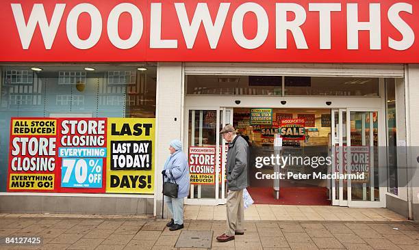 Shoppers pass a Woolworths shop on it's last day of trading on December 27, 2008 in New Malden, London. Almost 200 of Woolworths UK stores will close...