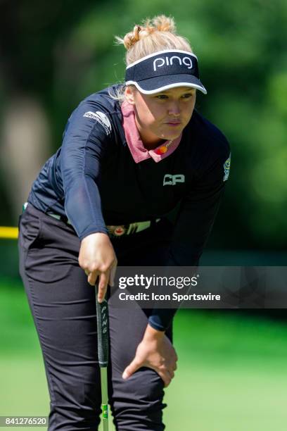 Brooke Henderson surveys the green before her putt on the 12th hole during the first round of the Canadian Pacific Women's Open on August 24, 2017 at...