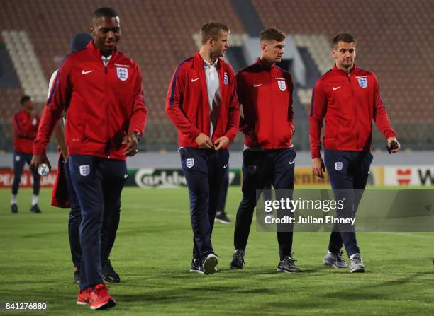 Eric Dier, John Stones and Tom Heaton of England in discussion as they inspect the pitch on the eve of the World Cup qualifying match against Malta...