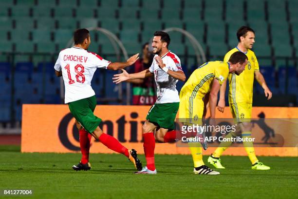 Bulgaria's midfielder Georgi Milanov celebrates with teammate Ivaylo Chochev after scoring a goal during the FIFA World Cup qualifying football match...
