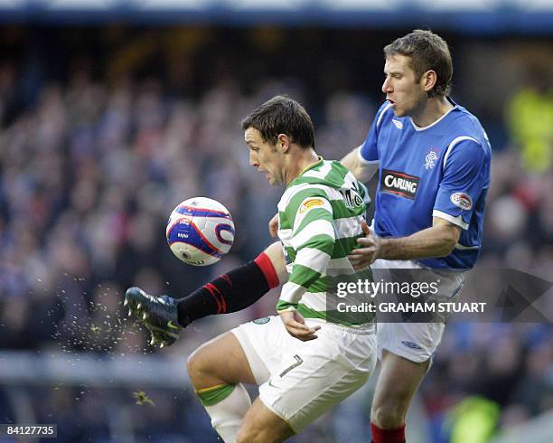 Kirk Broadfoot of Rangers tackles Scott McDonald of Celtic during a Scottish Premier League football match between Rangers and Celtic at Ibrox...