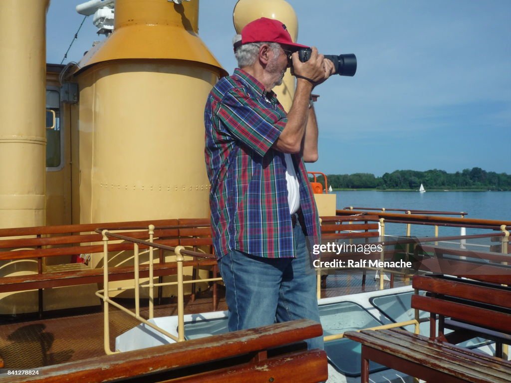 Senior photographed from the deck of paddlewheel steamers "Ludwig Fessler" at the Chiemsee, Bavaria - Germany