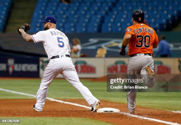 First baseman Mike Napoli of the Texas Rangers hauls in the throw from shortstop Elvis Andrus to complete the double play with the out at first base...