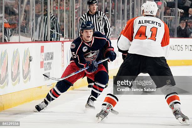 Derek Dorsett of the Columbus Blue Jackets flips the puck past Andrew Alberts of the Philadelphia Flyers on December 27, 2008 at Nationwide Arena in...