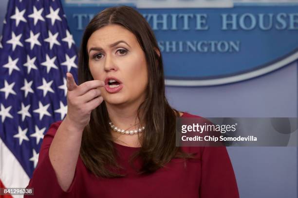White House Press Secretary Sarah Huckabee Sanders answers reporters' questions during a news conference in the Brady Press Briefing Room at the...