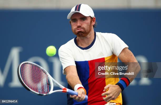 Bjorn Fratangelo of the United States returns a shot against Adrian Mannarino of France during their second round Men's Singles match on Day Four of...
