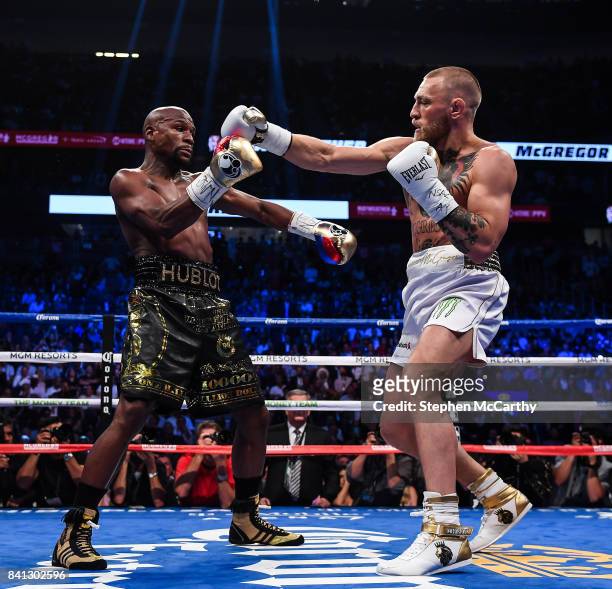Nevada , United States - 26 August 2017; Conor McGregor, right, and Floyd Mayweather Jr during their super welterweight boxing match at T-Mobile...