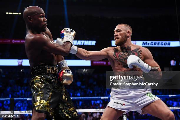 Nevada , United States - 26 August 2017; Conor McGregor, right, and Floyd Mayweather Jr during their super welterweight boxing match at T-Mobile...