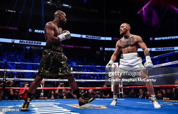 Nevada , United States - 26 August 2017; Conor McGregor, right, and Floyd Mayweather Jr during their super welterweight boxing match at T-Mobile...