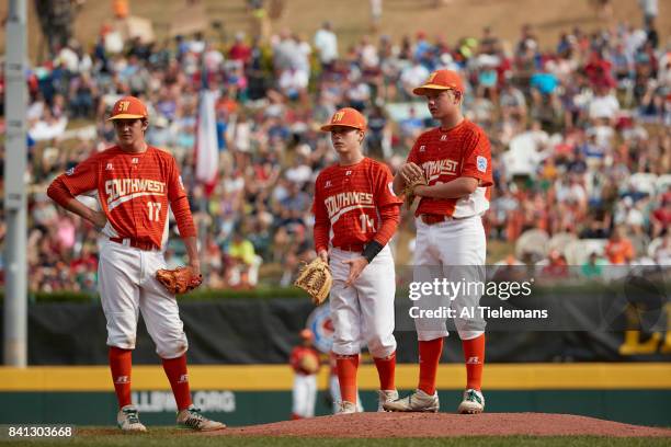 Little League World Series: USA Southwest Region Collin Ross , Blake Slaga , and Chip Buchanan waiting near mound vs Japan Region during Championship...