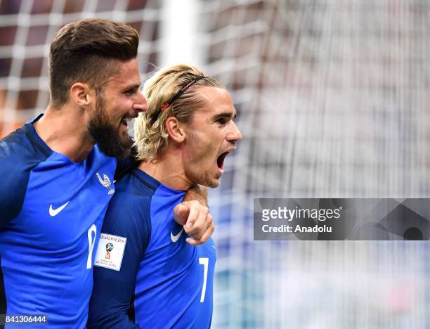 Antoine Griezmann of France celebrates with his team mate Olivier Giroud after scoring a goal during the FIFA World Cup 2018 qualifying Group A match...