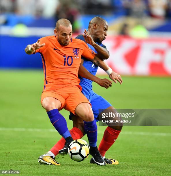 Djibril Sidibe of France in action against Wesley Sneijder of Netherlands during the FIFA World Cup 2018 qualifying Group A match between France and...