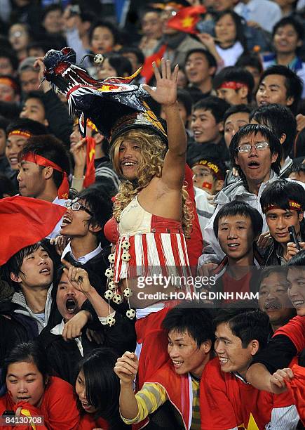 Vietnamese football supporters celebrate after their teams victory in the final of The AFF Suzuki Cup against Thailand at My Dinh Stadium in Hanoi on...