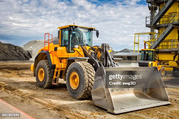 earth mover in front of cement plant - excavator imagens e fotografias de stock