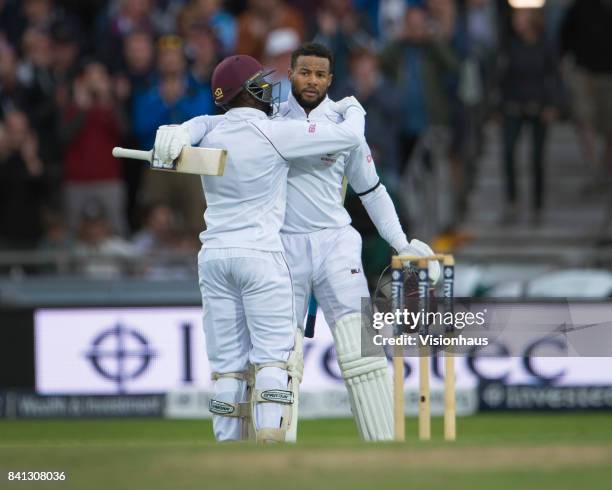 Shai Hope of West Indies acknowledges the applause of the crowd after hitting a century and is congratulated by team mate Jermaine Blackwood during...