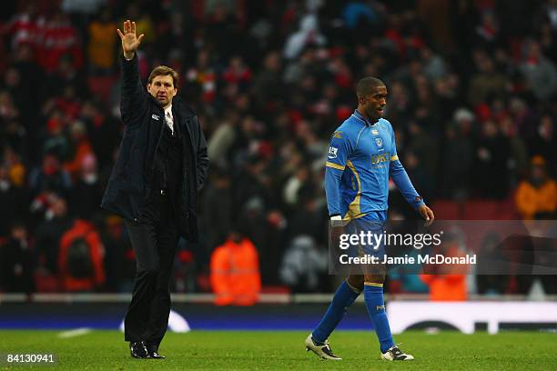 Tony Adams the Portsmouth manager and Sylvain Distin walk off at the end of the Barclays Premier League match between Arsenal and Portsmouth at the...